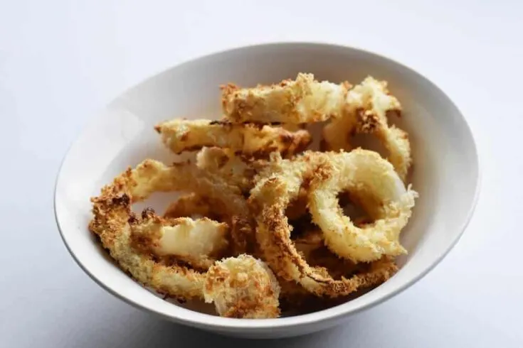 air fryer onion rings in a white bowl.