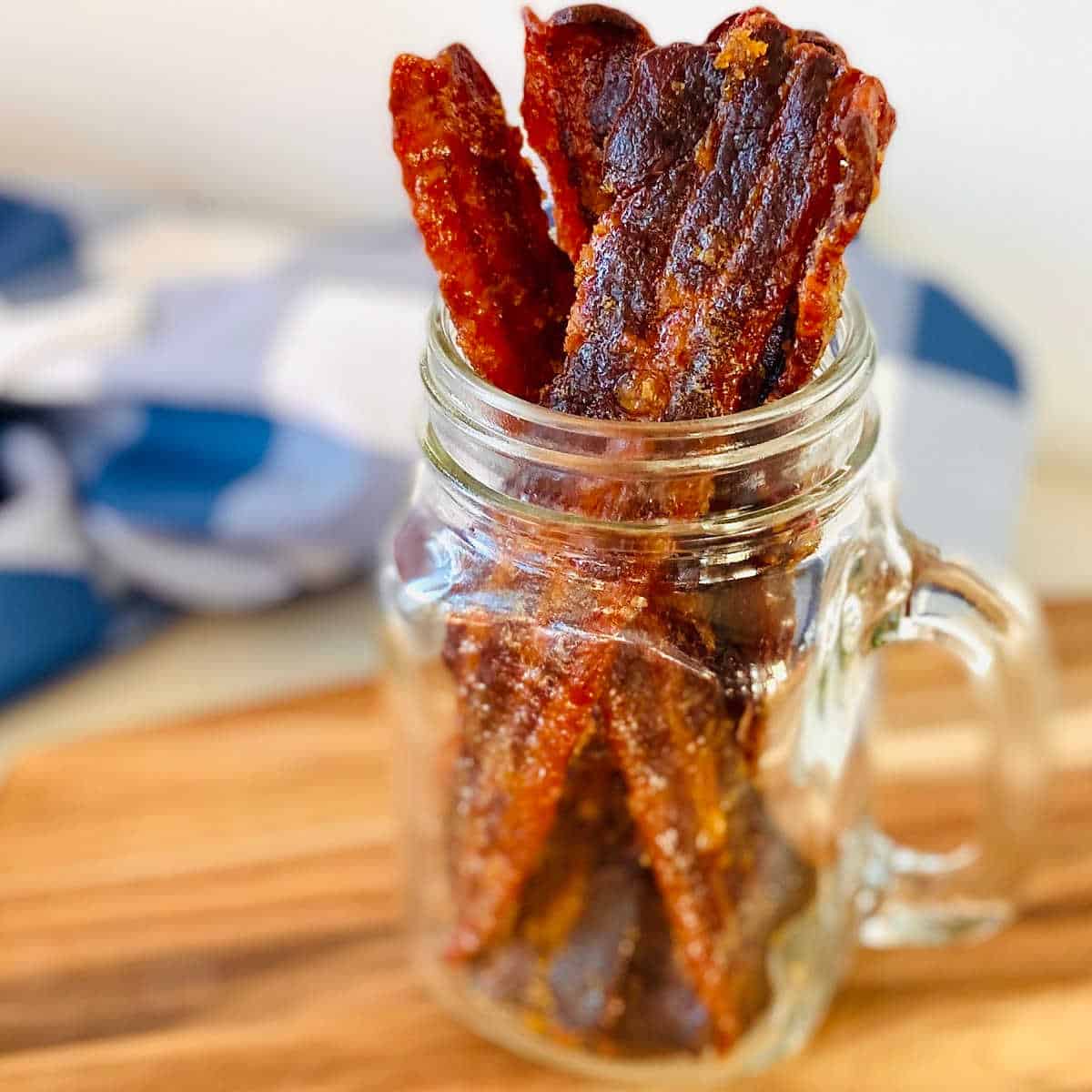 strips of bacon jerky in a mason jar.