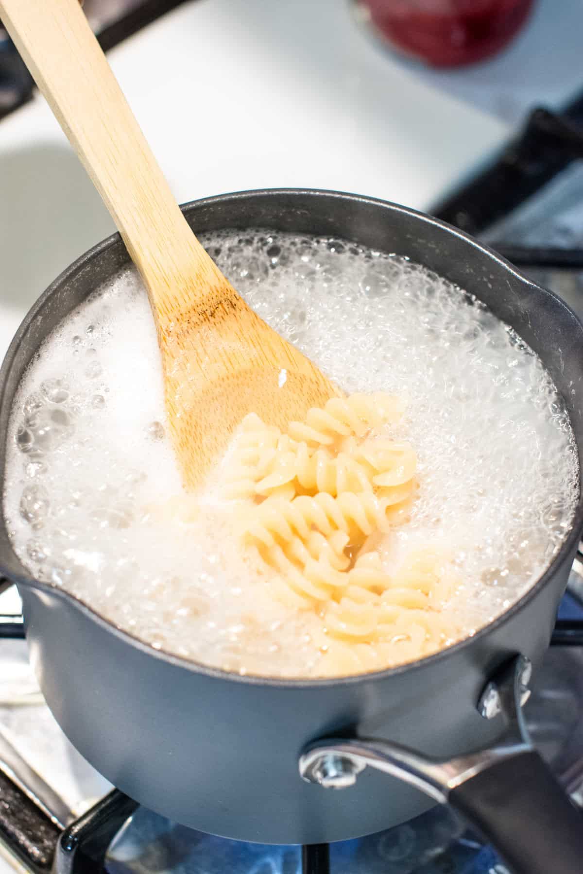 pasta cooking in a pot of boiling water.