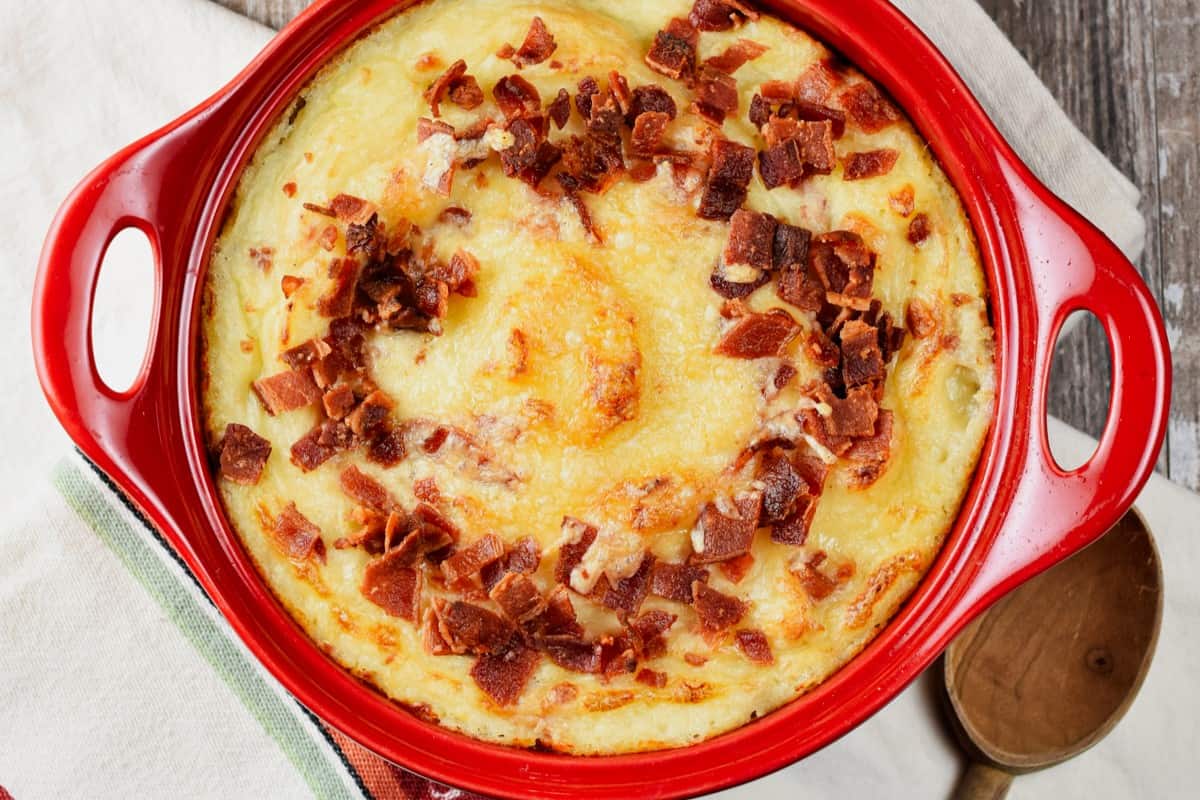 close-up overhead shot of baked mashed potatoes with bacon and cheese.