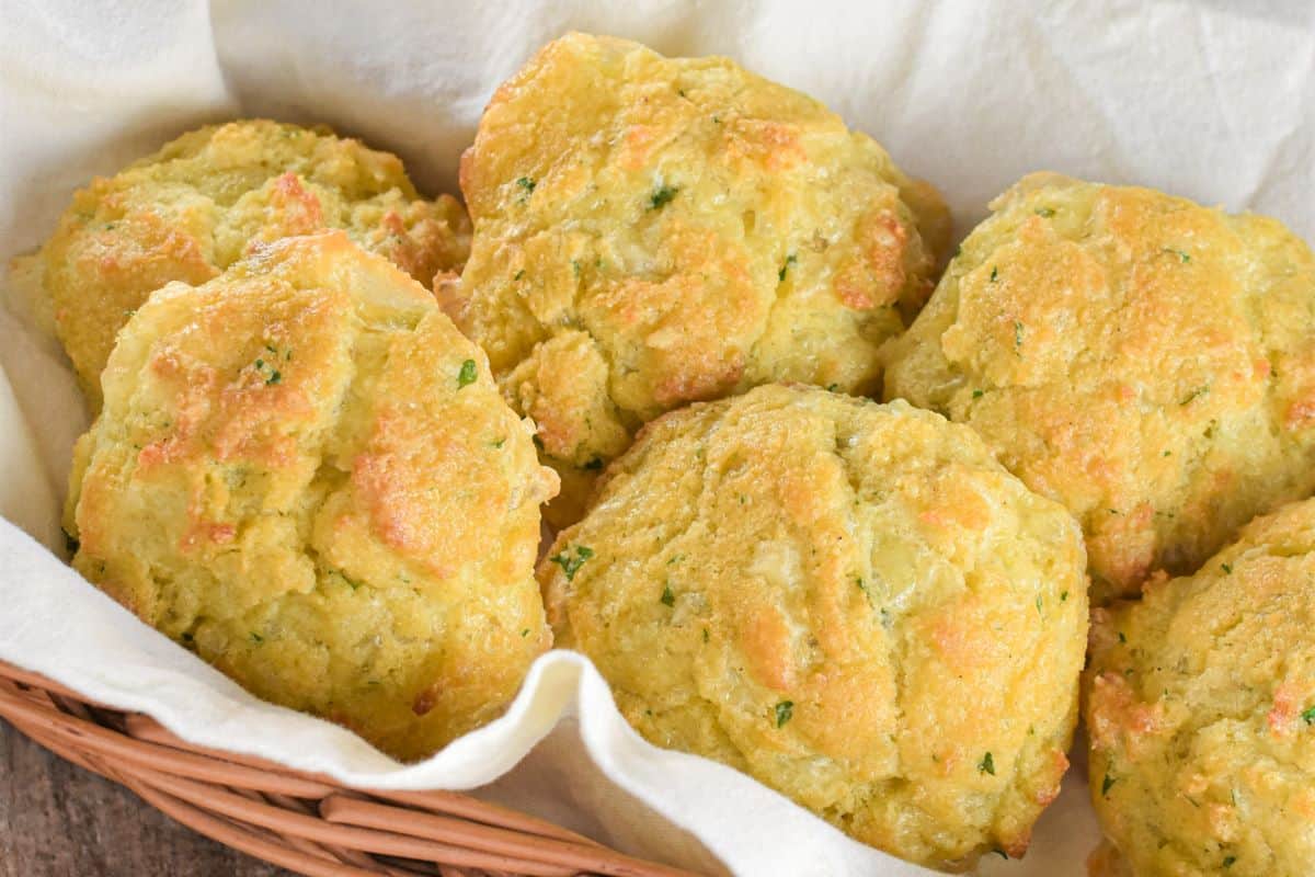 Close-up of biscuits in a napkin-lined basket.