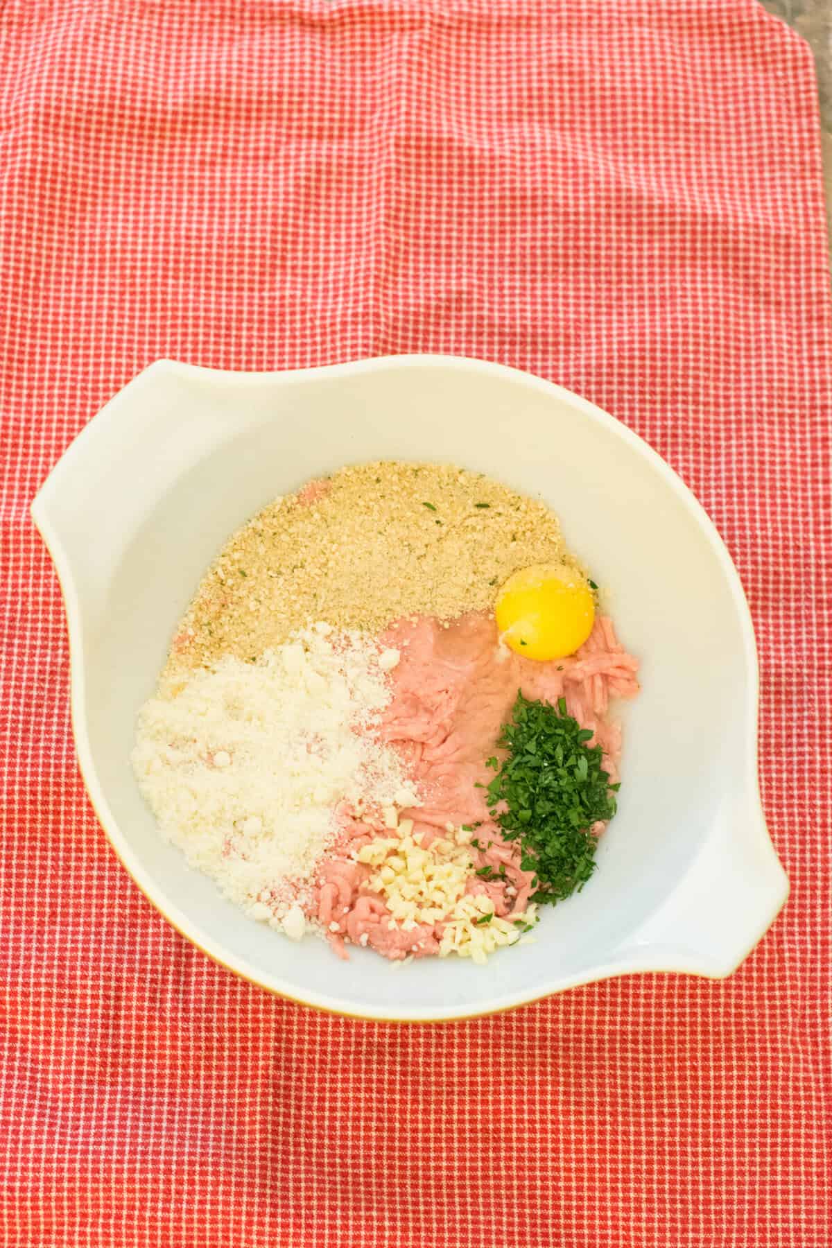 overhead of turkey meatball ingredients in a mixing bowl.