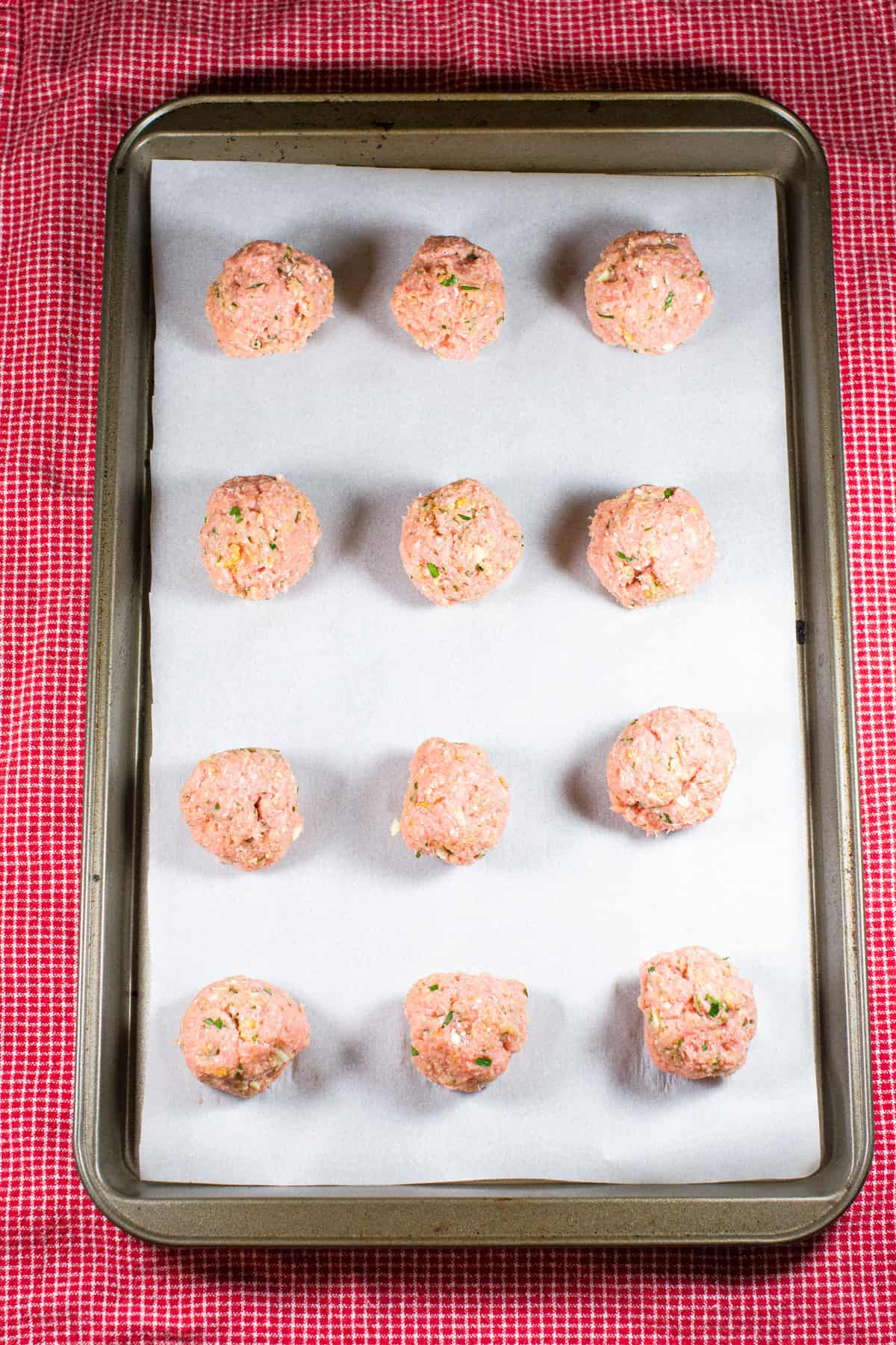 formed meatballs on a baking sheet with parchment paper.