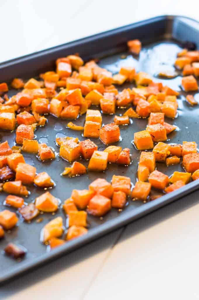 Roasted butternut squash on a baking sheet after cooking.