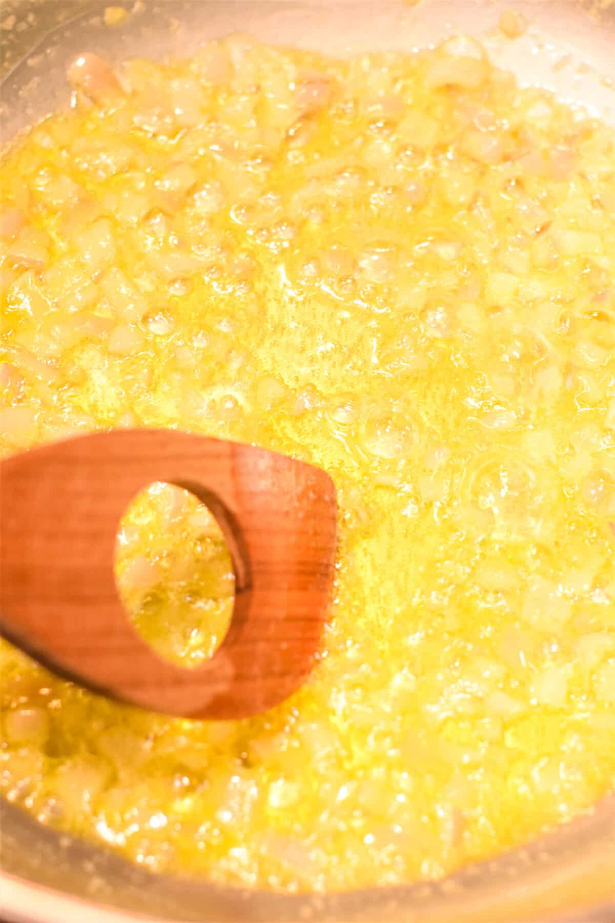 Cooking shallots in butter and oil in a pan.