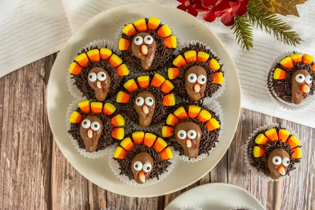 Turkey cupcakes on a wooden surface.