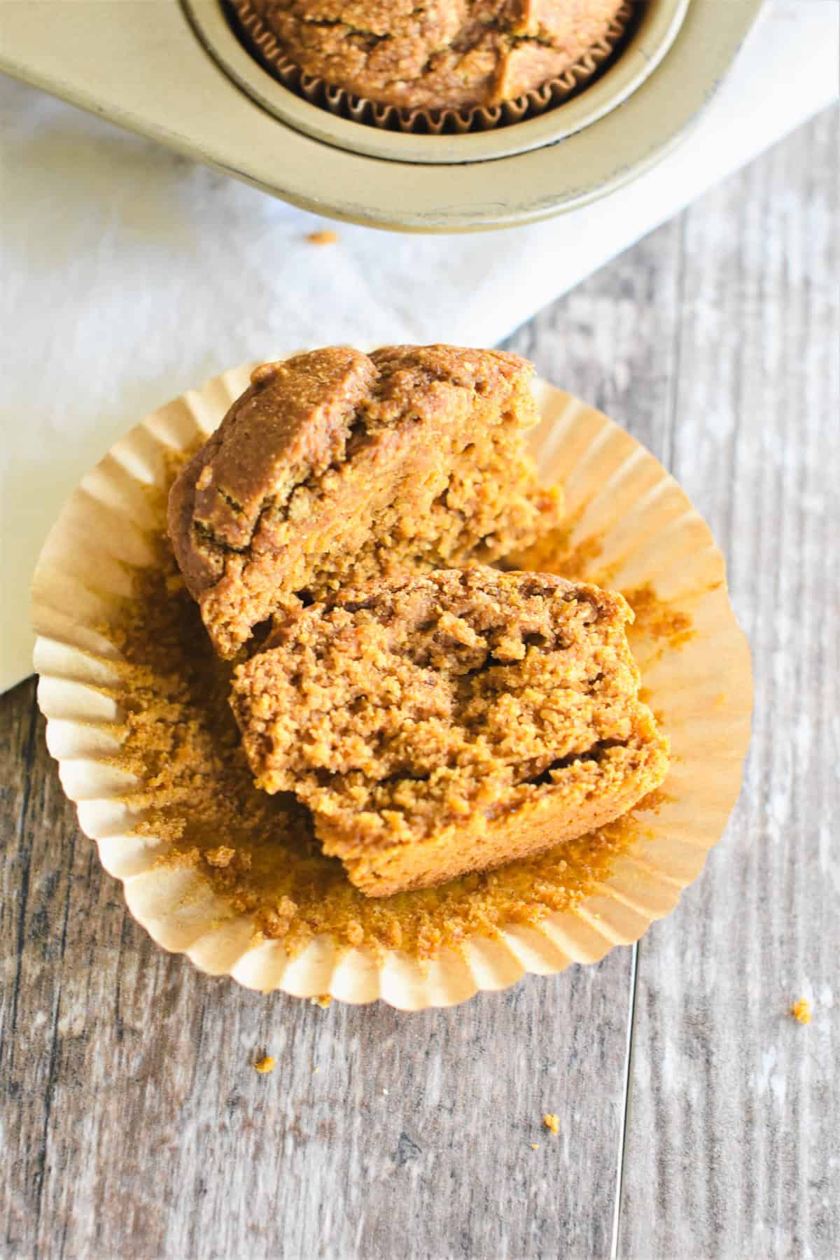 An open muffin on a parchment cupcake liner to show the moist interiior.