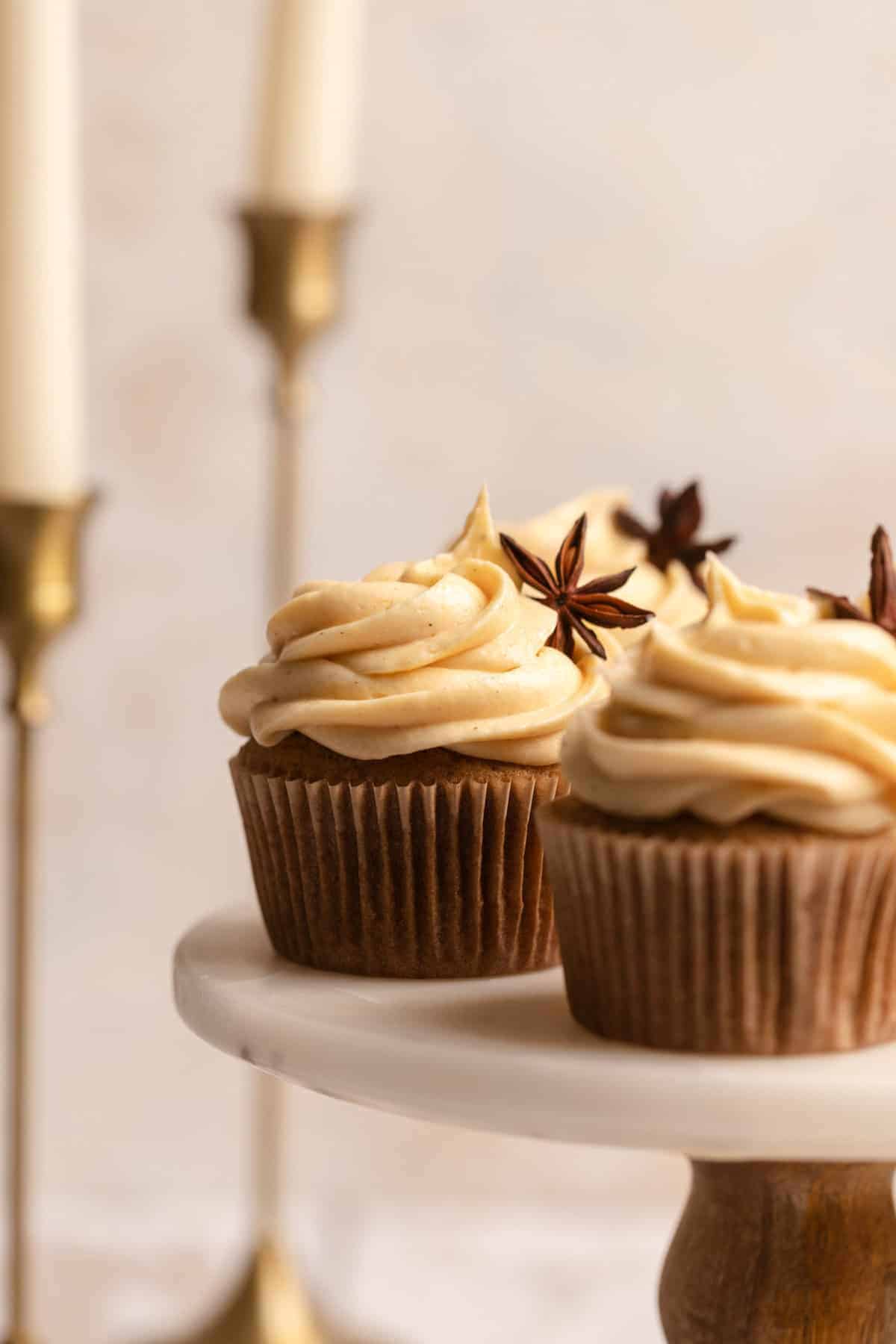 Pumpkin spice cupcakes on a cake stand.