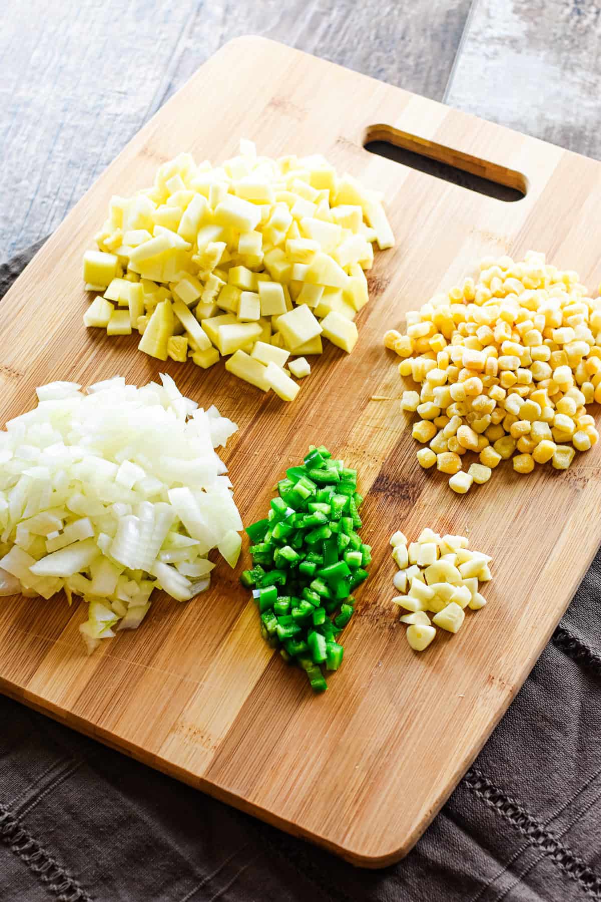 Chopped veggies on a wooden cutting board.