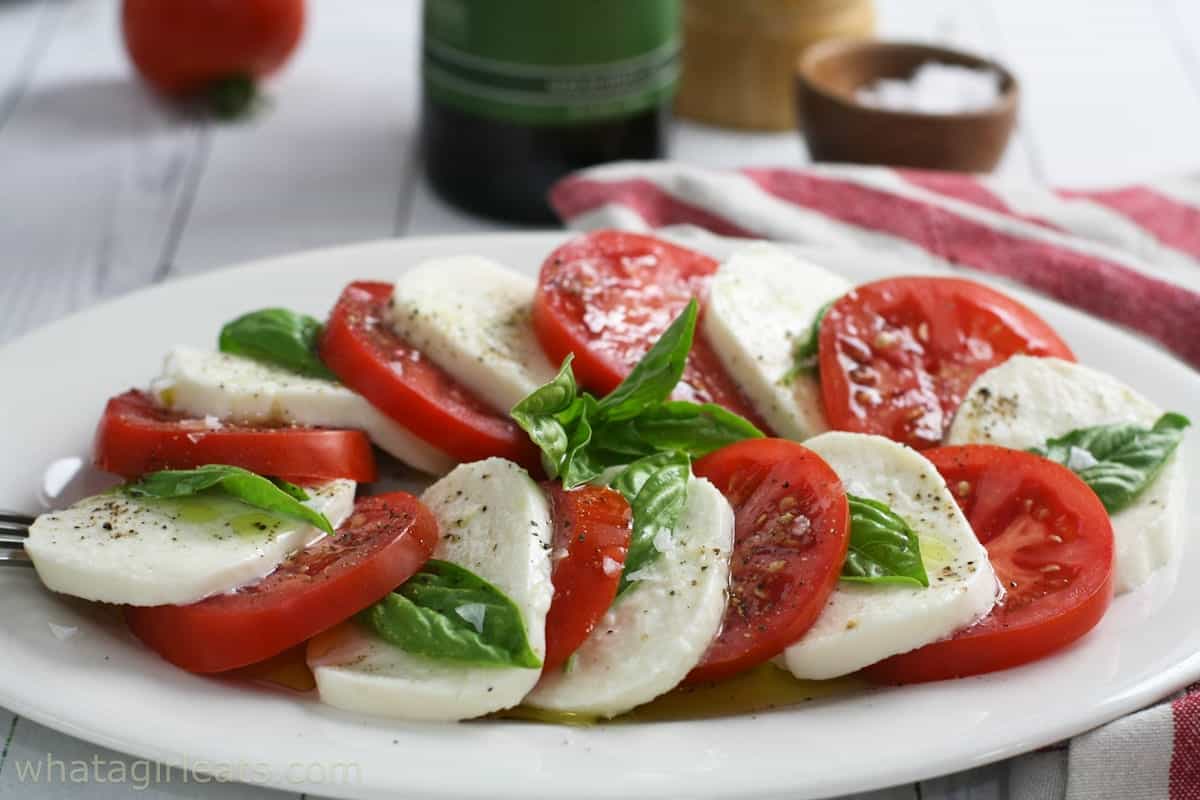 Caprese salad on a white plate.