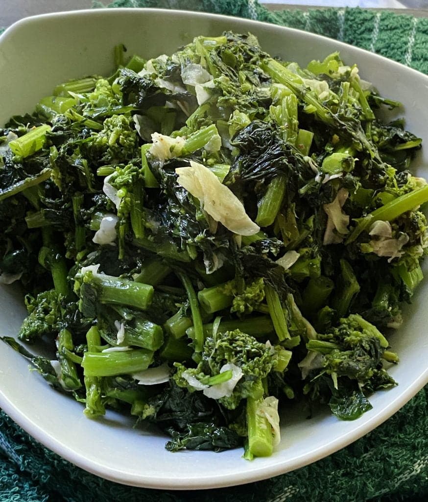 Sauteed rapini in a large white bowl.