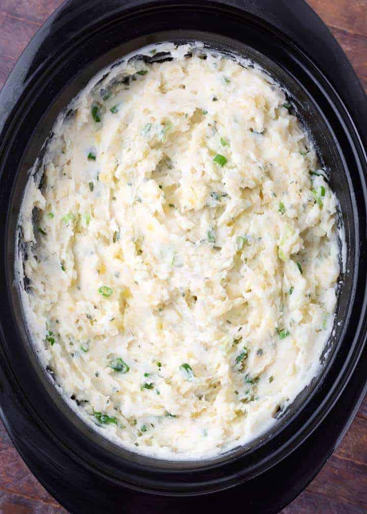 Sour cream and onion mashed potatoes in a slow cooker.