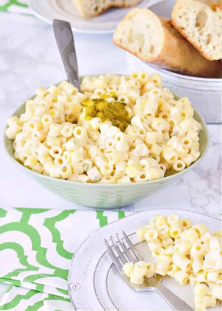 A serving bowl with Hawaiian pasta salad and some on a plate.
