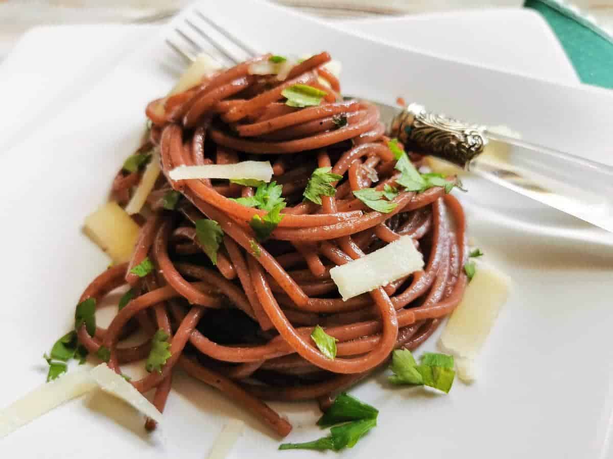A serving of drunken spaghetti on a white plate.