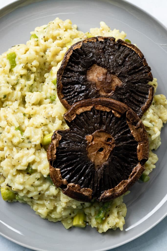 Vegan asparagus risotto with portobello mushroom caps.