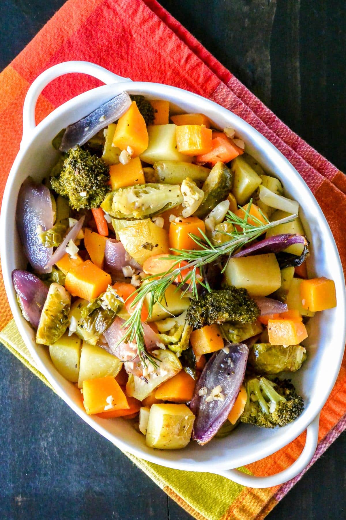 Roasted vegetables in a white casserole dish.