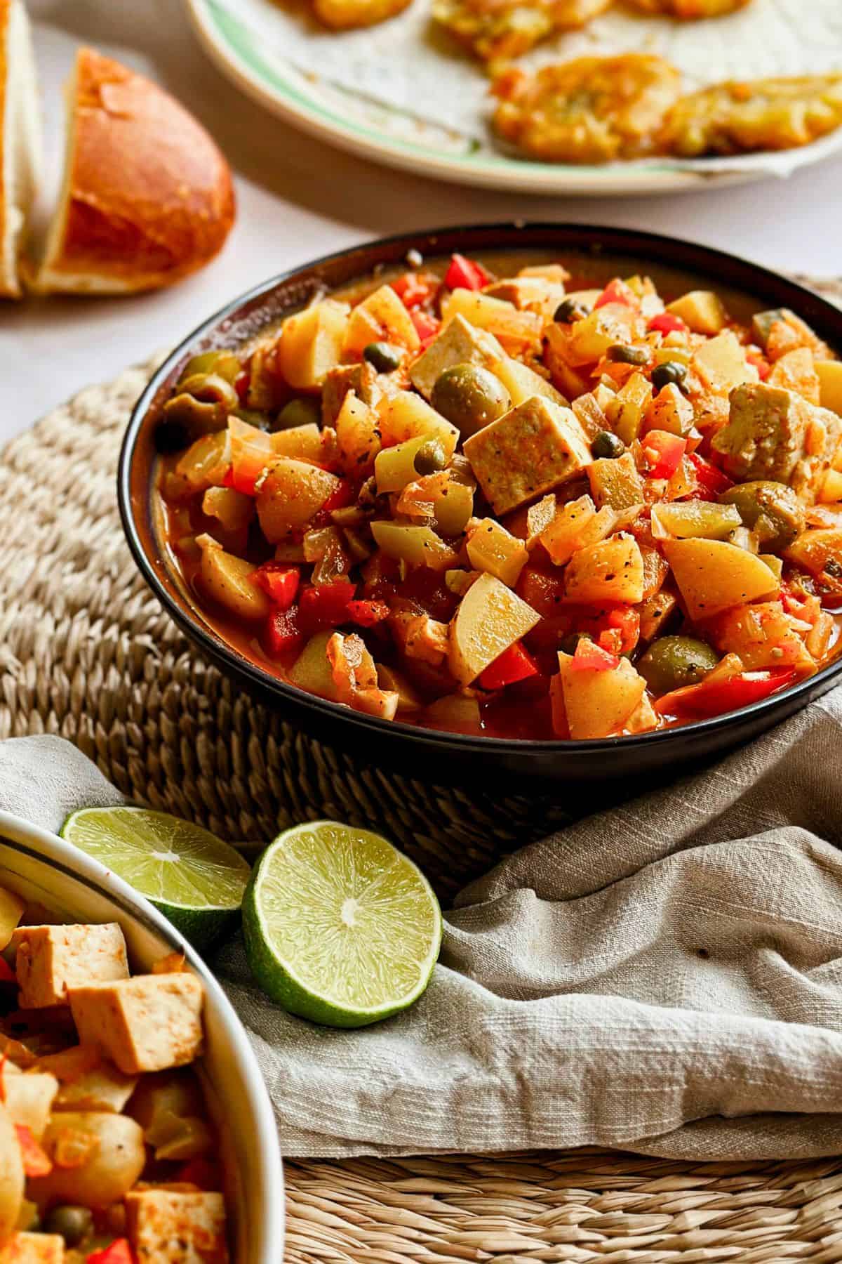 Vegan tofu fricase in a black bowl.