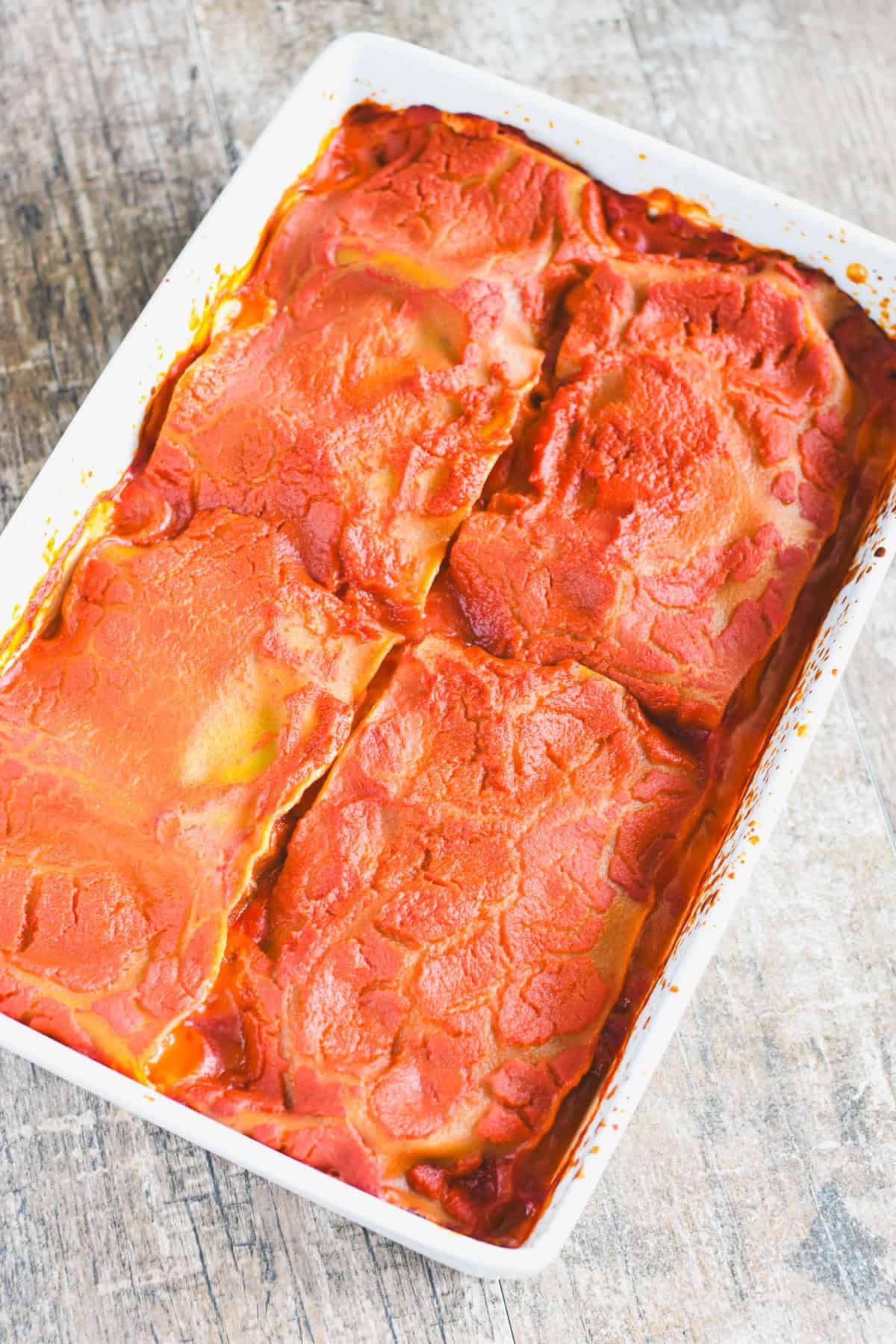 Lasagna in a white casserole dish after baking.